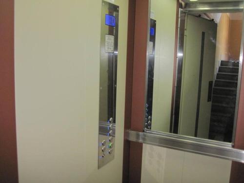 a bathroom with a mirror and a walk in shower at Apartment Letna near the city center in Košice