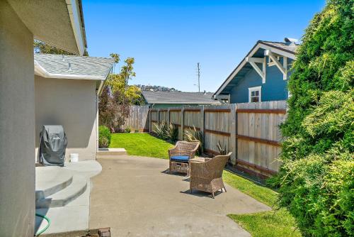a patio with two chairs and a fence at Verdon Oasis in Morro Bay