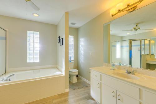 a bathroom with a tub and a sink and a toilet at 8 Mi to Rainbow Springs Dunnellon Area Home! in Dunnellon