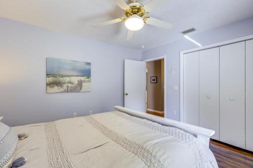 a white bedroom with a bed and a ceiling fan at 8 Mi to Rainbow Springs Dunnellon Area Home! in Dunnellon