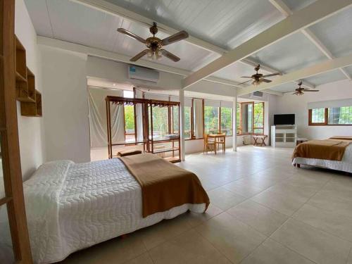 a bedroom with two beds and a flat screen tv at Posada de San Isidro in San Isidro