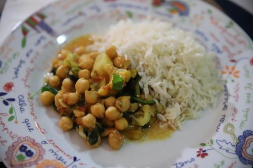 a plate of food with rice and beans andottage at Quinta da Cerdeira in Seia