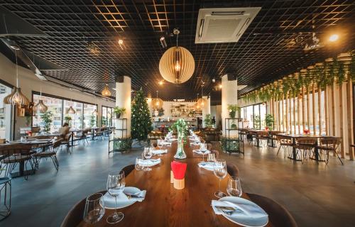 a restaurant with a long wooden table and chairs at Luxury Two Bedroom Penthouse in Caesar Resort & SPA, Long Beach in Perivolia tou Trikomou