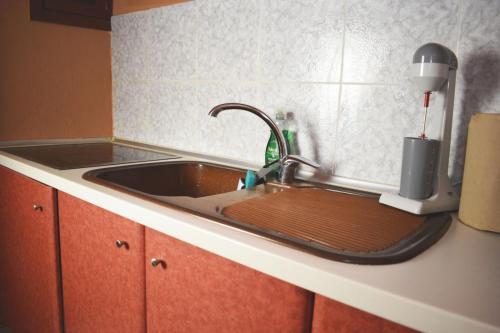 a kitchen counter with a sink with a mixer at MYRTOS ROOMS in Paralia Katerinis