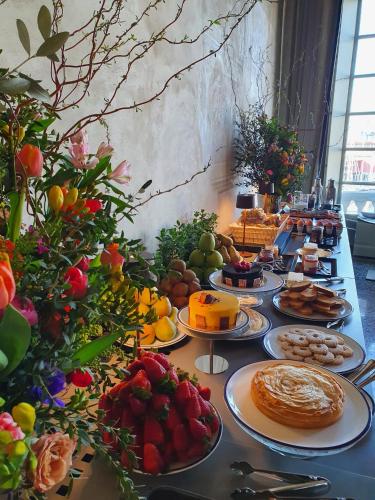 a long table with plates of food on it at Hotel Palazzo Durazzo Suites in Genova