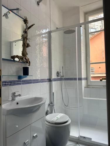 a bathroom with a shower and a toilet and a sink at Affittacamere Via Prione in La Spezia