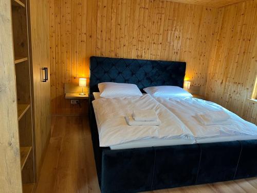 a bed with two towels on it in a room at Seeblick Apartment am Mellensee in Mellensee