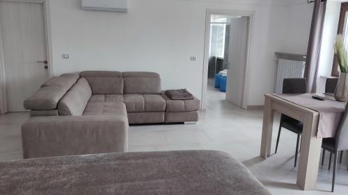 a living room with a couch and a table at Nautica Tarello - Casa Ena BeB in Viverone