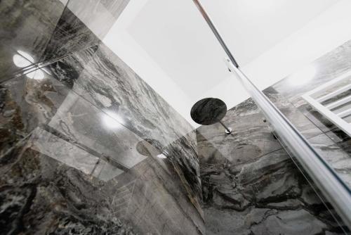 a shower in a bathroom with a glass wall at "Home Big CrIré, at '724" in Rome