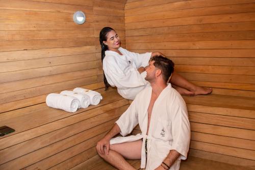 a woman sitting next to a man in a sauna at Hotel Florida Sinú in Montería