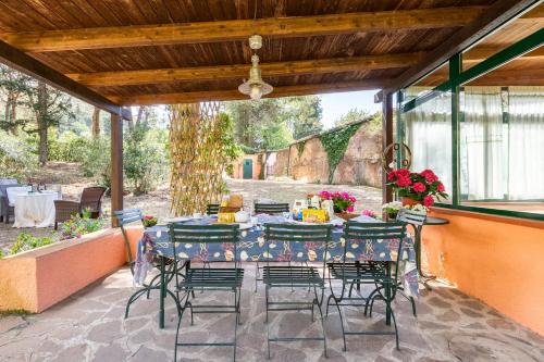 a table and chairs on a patio at The Old Mill with Private Garden and Torrent in Portoferraio