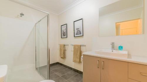 a bathroom with a shower and a sink at 1-83 Thompson Avenue, Cowes in Cowes