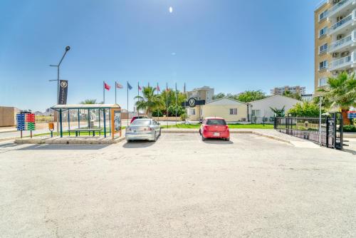 two cars parked in a parking lot next to a bus stop at Luxury Two Bedroom Penthouse in Caesar Resort & SPA, Long Beach in Perivolia tou Trikomou