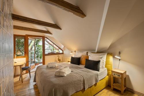 a bedroom with a large bed in a room with a desk at Bohemian Chic 2 Bedroom 2 Bathroom Loft with Hanging Chair in Prague