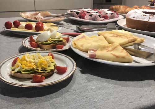 a table with plates of different types of food at Villa Mameli b&b in Rena Majore
