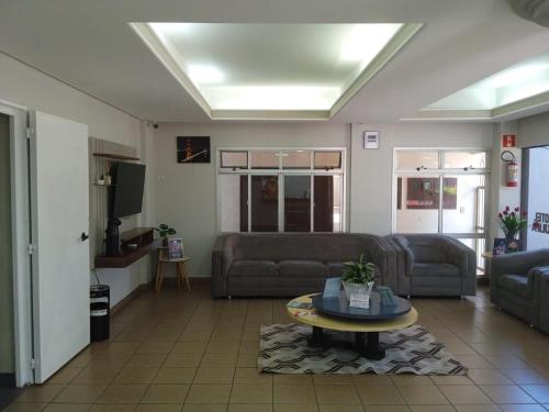 a living room with a couch and a table at Tulipa Hotel in Foz do Iguaçu