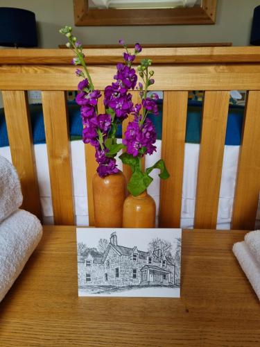 a drawing of a house and purple flowers on a table at Craggan in Ballater