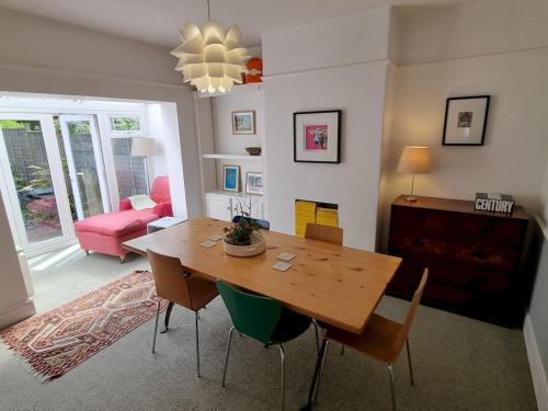 a dining room with a wooden table and chairs at Pass the Keys Cheerful 2 bed home with garden near Exeter centre in Exeter