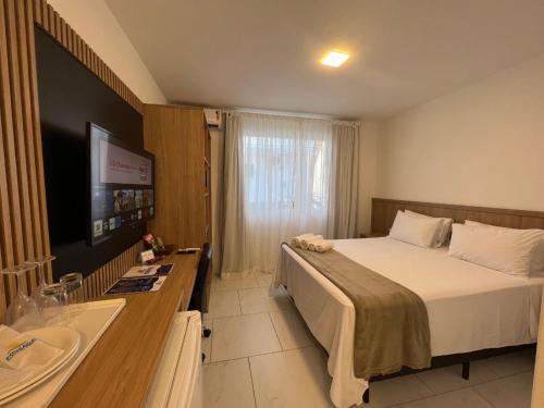 a hotel room with a bed and a sink at Pousada Recanto Forte in Florianópolis