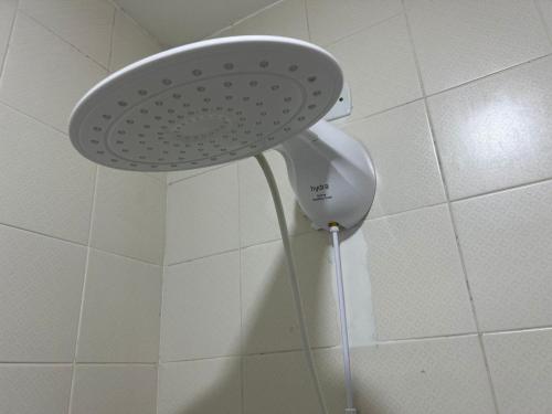 a shower with a white shower head in a bathroom at Pousada Recanto Forte in Florianópolis