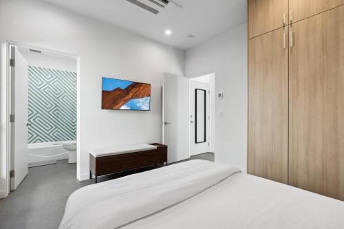 a white bedroom with a bed and a window at Unique Design 1-bedroom Apartment - 80 Walkscore! in Phoenix