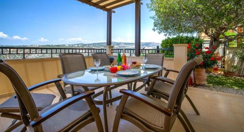 a table and chairs on a balcony with a view at Fantastic Junior Villa CZ02 Salamis with Gorgeous Views, Aphrodite Hills in Kouklia