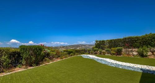 an overhead view of a green lawn with a mountain in the background at Fantastic Junior Villa CZ02 Salamis with Gorgeous Views, Aphrodite Hills in Kouklia