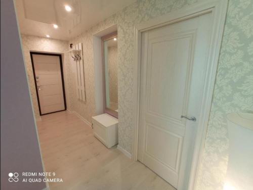 a hallway with a white door in a room at Comfortable apartment in center in Narva