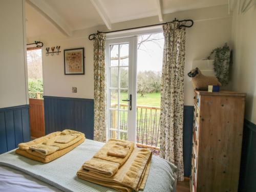 a bedroom with a bed with two towels on it at Mucklewick Hollow in Shrewsbury