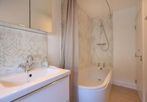 a bathroom with a sink and a bath tub at Smugglers Cove in North Berwick