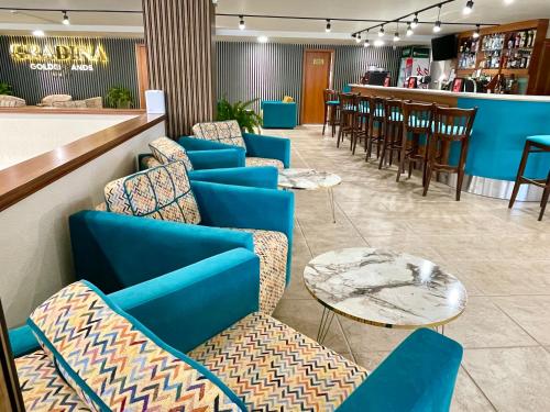 a lobby with blue chairs and tables and a bar at BSA Gradina Hotel & Aquapark - All Inclusive in Golden Sands
