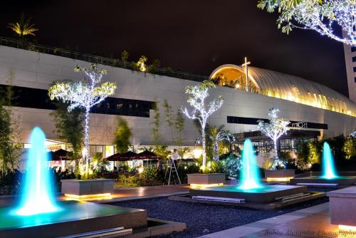 a building with blue lights in front of a building at Avant Apartments at The Fort in Manila