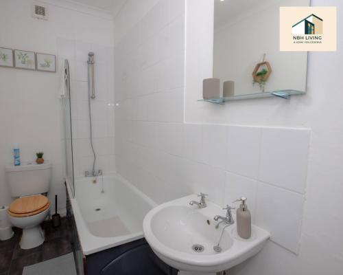 a white bathroom with a sink and a toilet at Three Modern Double Bed Apartment By NBH Living Short Lets & Serviced Accommodation in Brighton & Hove