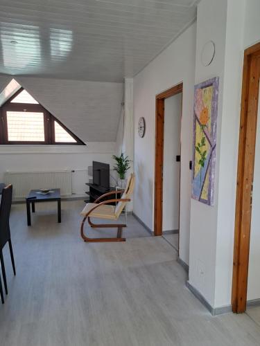 a living room with a chair and a table at Apartment Oase in Balatonszemes