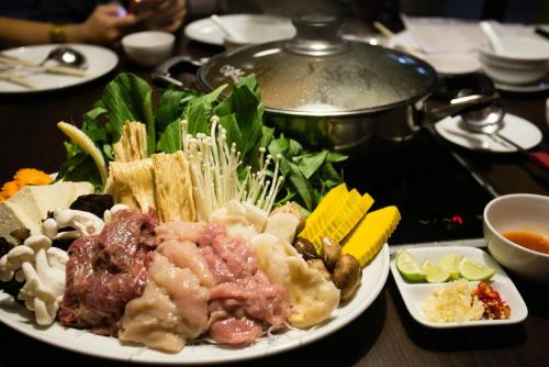 a plate of food with meat and vegetables on a table at Avant Apartments at The Fort in Manila