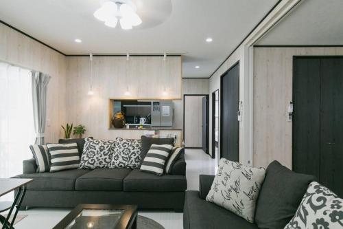 a living room with a couch and a kitchen at Vacation House Jo in Agarii
