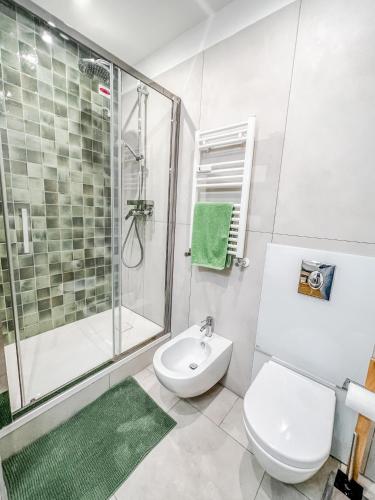 a bathroom with a shower and a toilet and a sink at Casa 3 Santi, your contemporary home in Rome in Rome