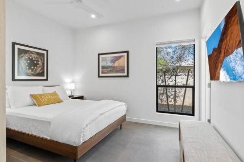a white bedroom with a bed and a window at Modern 1-bedroom Apartment - 80 Walkscore! in Phoenix
