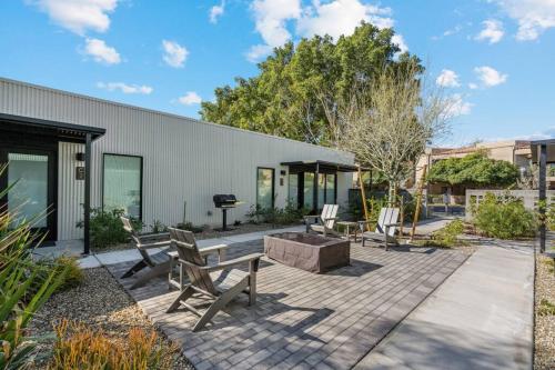 a patio with benches and a grill in front of a building at Modern 1-bedroom Apartment - 80 Walkscore! in Phoenix