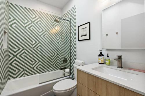 a bathroom with a toilet and a sink and a tub at Unique Design 2-bedroom Apartment - 80 Walkscore! in Phoenix