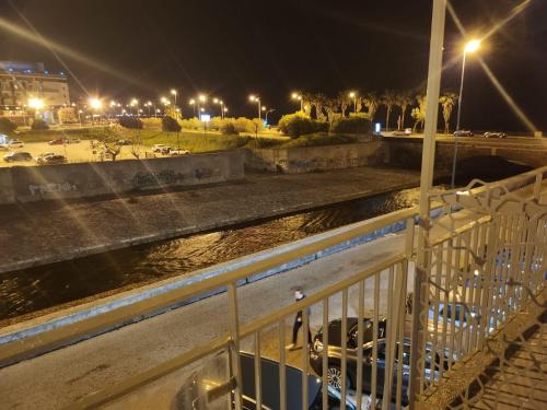 a bridge over a river at night with cars at B&B Mini Hotel Incity-close train station and port- in Salerno