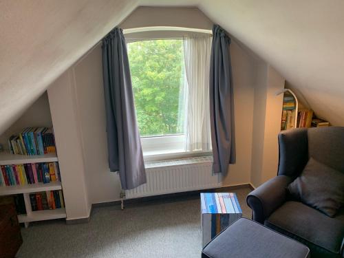 a living room with a window and a chair at Res a Ros 26 in Wangerooge