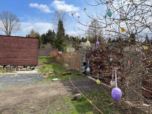a garden with a tree with easter eggs on it at Fox House Tisá / Rájec in Tisá