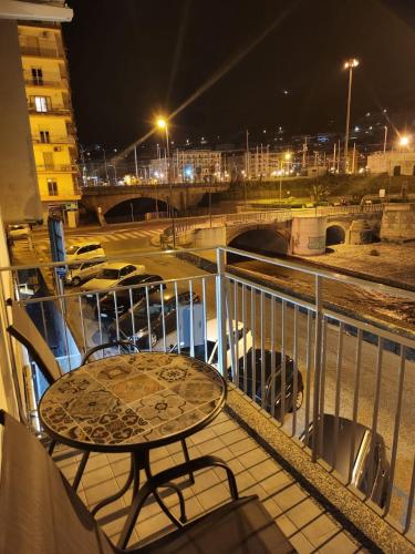 a table and chairs on a balcony at night at B&B Mini Hotel Incity-close train station and port- in Salerno