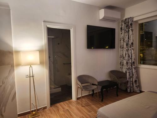 a bedroom with a bed and a television on the wall at B&B Mini Hotel Incity-close train station and port- in Salerno