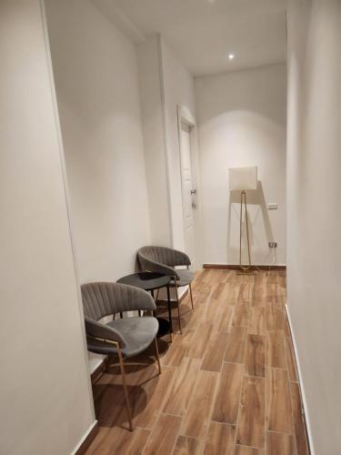 a room with chairs and a painting on the wall at B&B Mini Hotel Incity-close train station and port- in Salerno