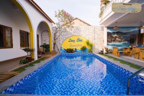 ein Schwimmbad in einem Haus mit blauen Fliesen darauf in der Unterkunft Làng Chài Homestay Phú Yên in Phu Yen