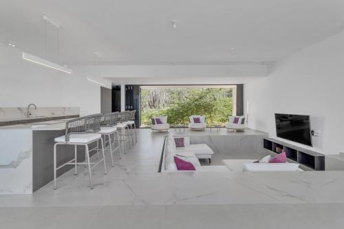 a living room with white furniture and a large window at Villa Regatta in Hato