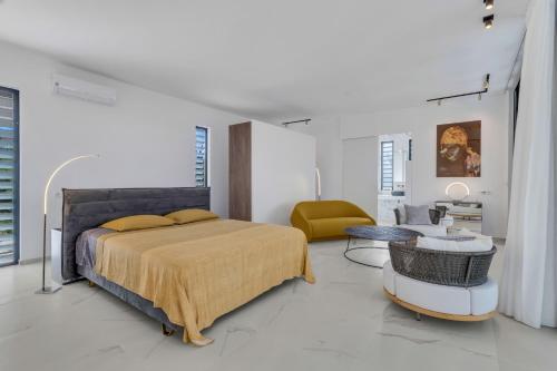 a bedroom with a bed and a living room at Villa Regatta in Hato