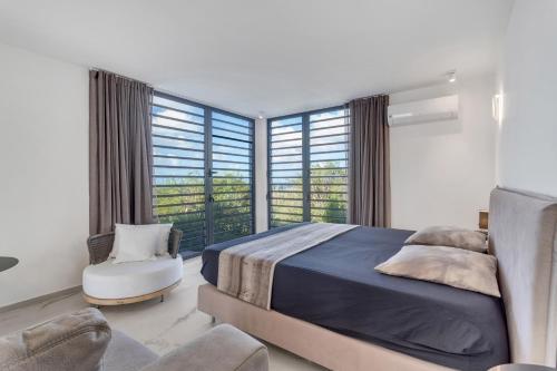 a bedroom with a bed and a large window at Villa Regatta in Hato